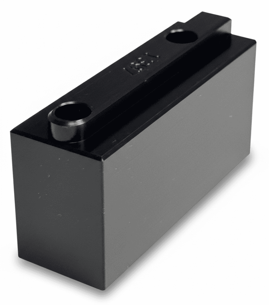 Metal black block with two circular holes on the top, likely a machined component used for precision engineering applications.