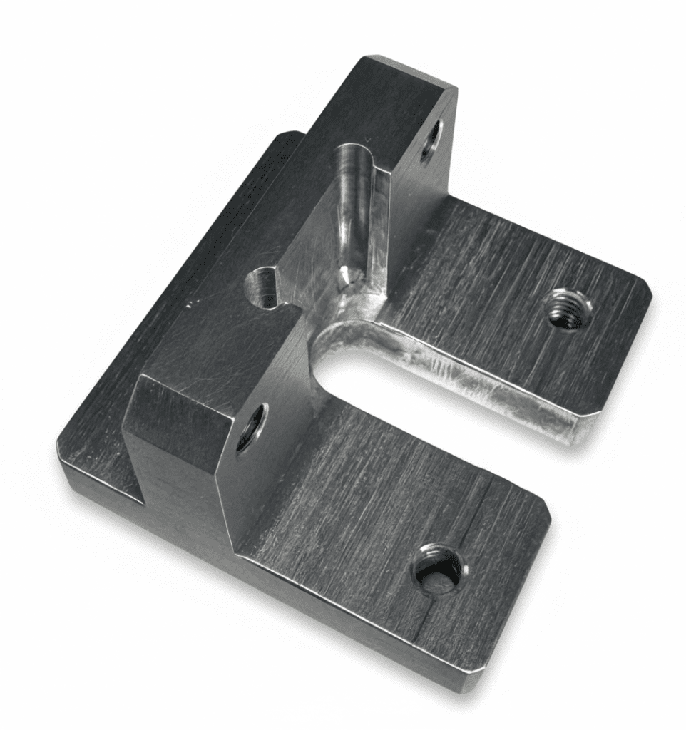 A machined metal bracket with a U-shaped cutout, flat surfaces, and two threaded holes, placed on a white background.